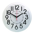 Round wall clock with oversized black numerals on a white dial and a black frame