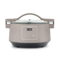Clay-colored 8-quart slow cooker with locking glass lid, display screen, and side handles.
