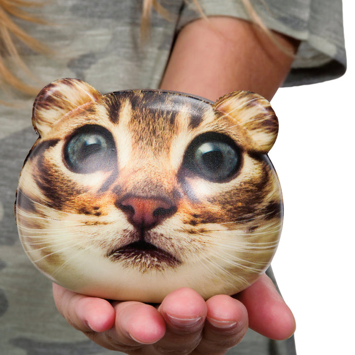 A person holds the Astroverse Catstronaut pouch by Astroverse, featuring a cat’s face with big eyes and ear shapes, resembling a space explorer, set against a blurred background.