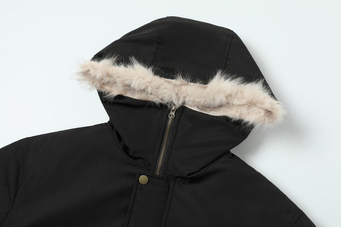 Close-up of black hood with cream faux fur trim and front zipper