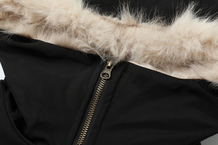 Close-up of cream faux fur hood trim and zipper pull on black jacket