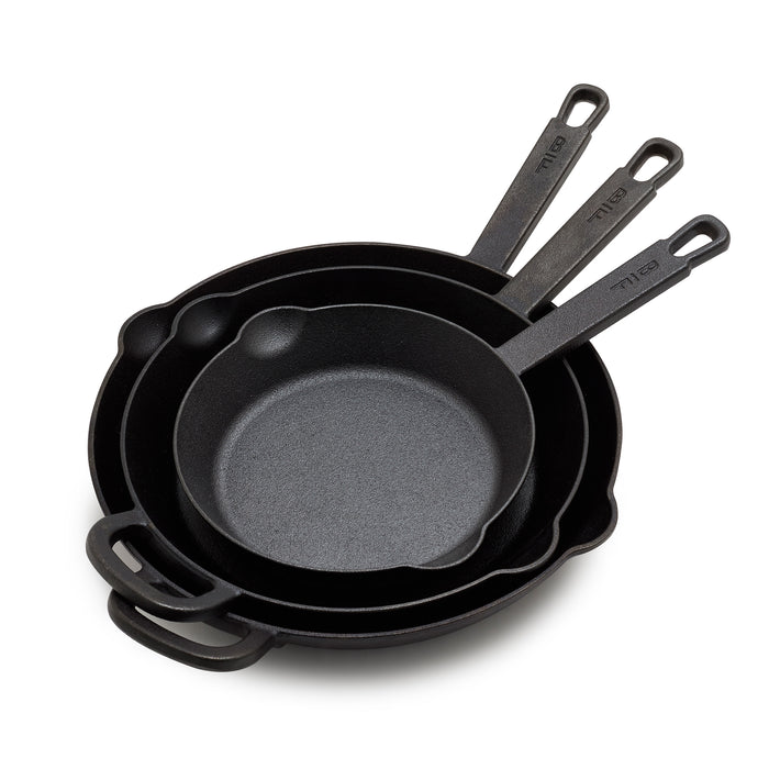The Bobby Flay by GreenPan 8", 10" and 12" Cast Iron Frypan Set includes three nested pans, each with a roomy cooking surface and long handle with a hanging hole—heirloom-quality cast iron skillets made for everyday use.