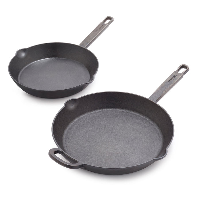 The Bobby Flay by GreenPan 8" and 10" Cast Iron Frypan Set features two black skillets with long handles, one with an extra small handle. These heirloom-quality pans are empty on a white background—ideal for any modern kitchen.