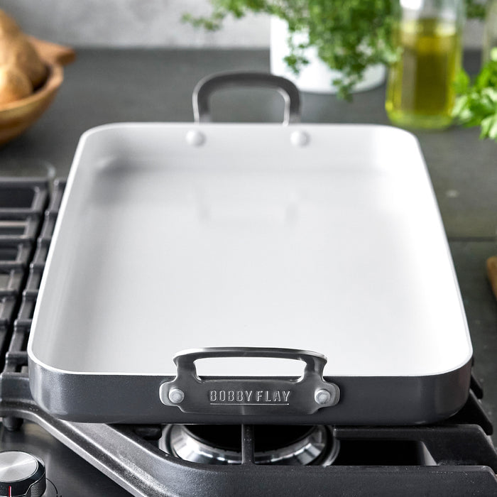 Graphite ceramic nonstick double burner griddle on a stovetop, 18x11 size.