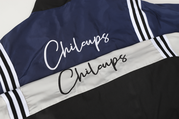 Folded navy and white Chilcups jackets showing back script on the upper panels