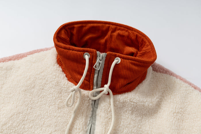 Close-up of orange ribbed high collar with cream drawcords and front zipper