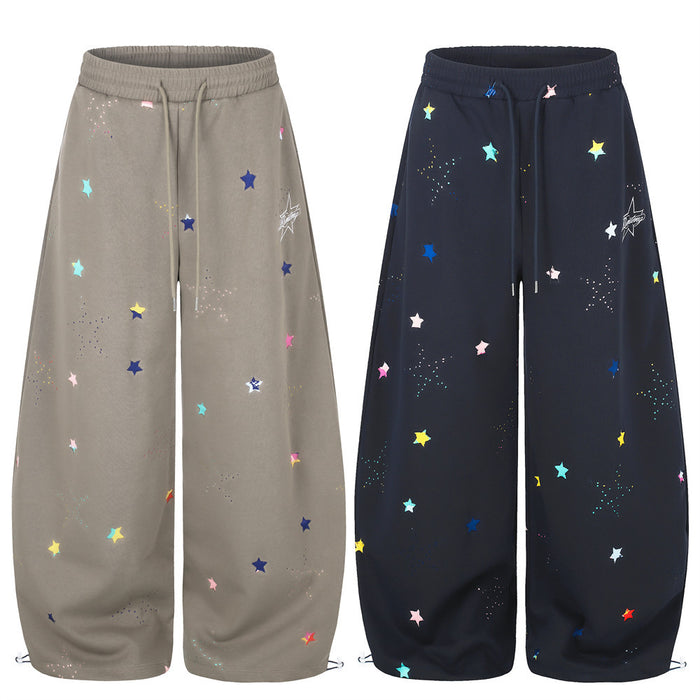 Wide-leg sweatpants shown in taupe and black with multicolor star print
