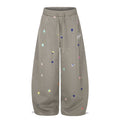 Taupe wide-leg sweatpants with multicolor star print, front view