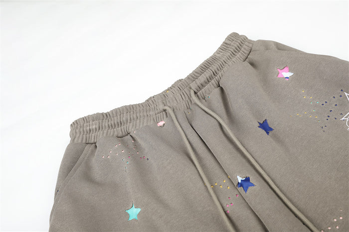 Close-up of taupe sweatpants waistband and drawstring with star print