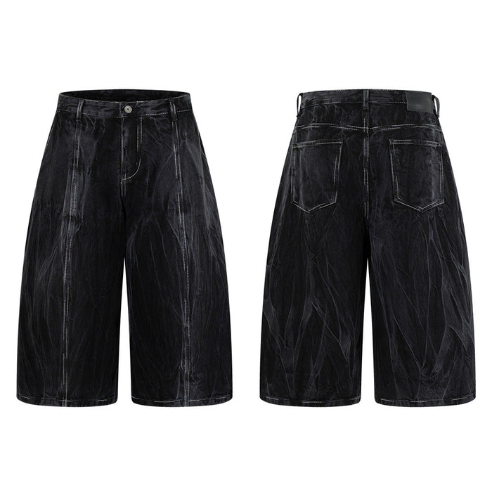 Crinkle-washed black wide-leg denim shorts with contrast white topstitching, front and back view