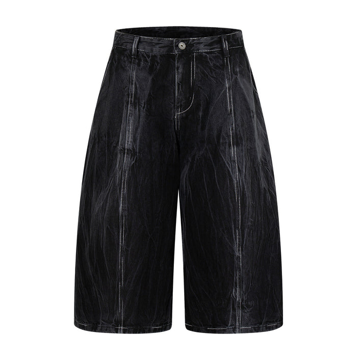 Black crinkle-washed denim shorts, front view with wide legs and white contrast stitching