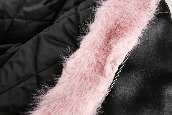 Close-up of pink faux fur hood lining beside black leather zipper front
