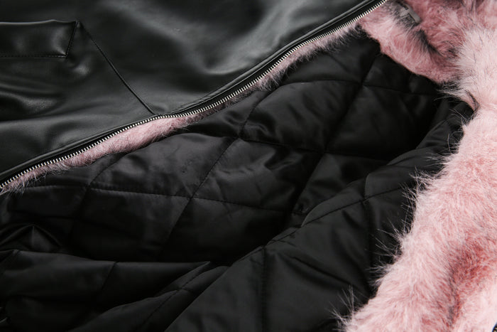 Close-up of black quilted lining and pink faux fur interior at the zipper
