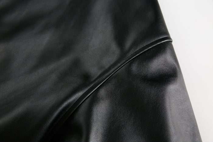 Close-up of black PU leather sleeve seam and texture detail