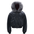 Front view of a cropped black PU leather bomber jacket with an oversized grey faux-fur trimmed hood and silver zip closure