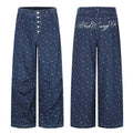 Dark blue wide-leg jeans front and back views with small floral print and script embroidery