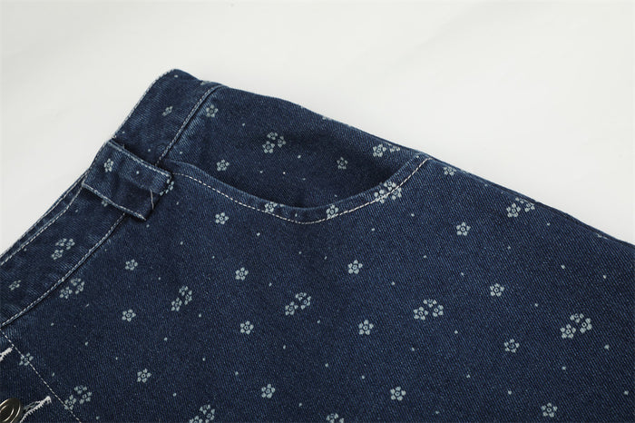 Close-up of dark blue denim upper back panel with small floral print and top waistband