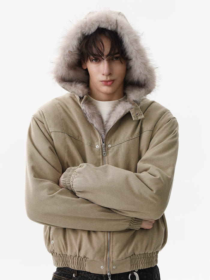 Tan bomber jacket worn with hood up and faux fur framing the face