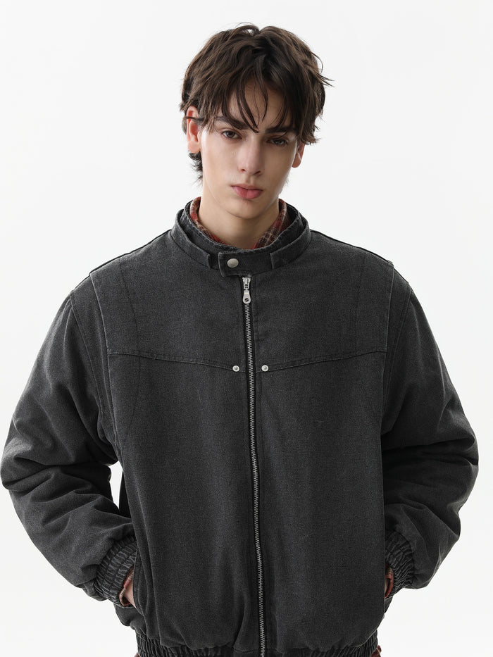 Black bomber jacket worn closed, front view with ribbed cuffs and hem