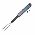 Taylor digital fork thermometer with two stainless steel prongs and gray body showing a blue backlit display
