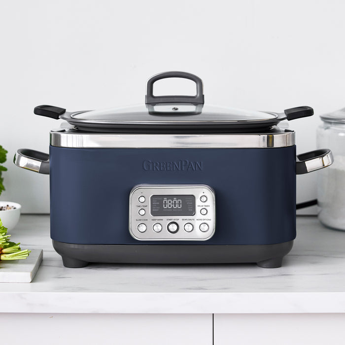 Blue slow cooker with digital display on a white countertop