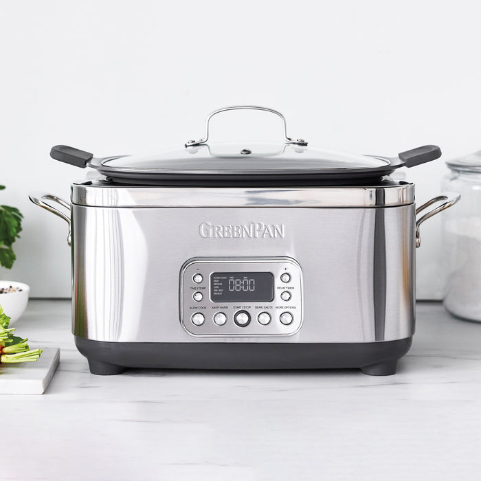 Stainless steel slow cooker with digital display on a white countertop