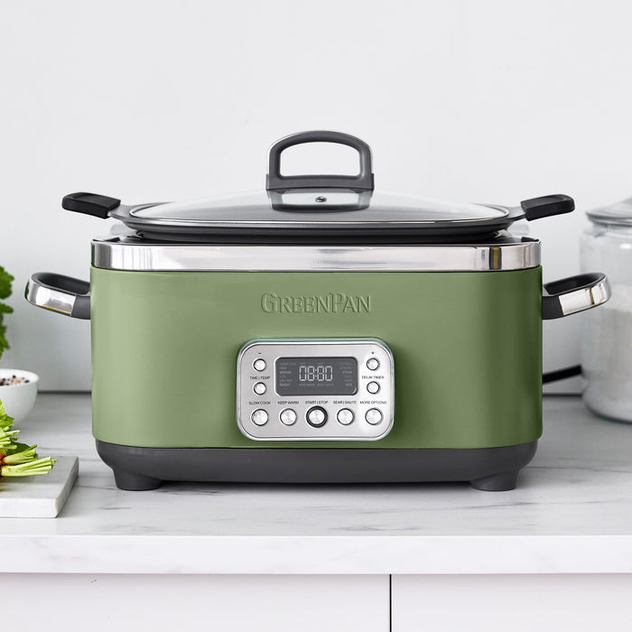 Green slow cooker with digital display on a white countertop