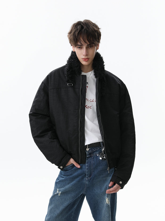 Black bomber jacket worn open on a model, showing faux fur collar and zip front
