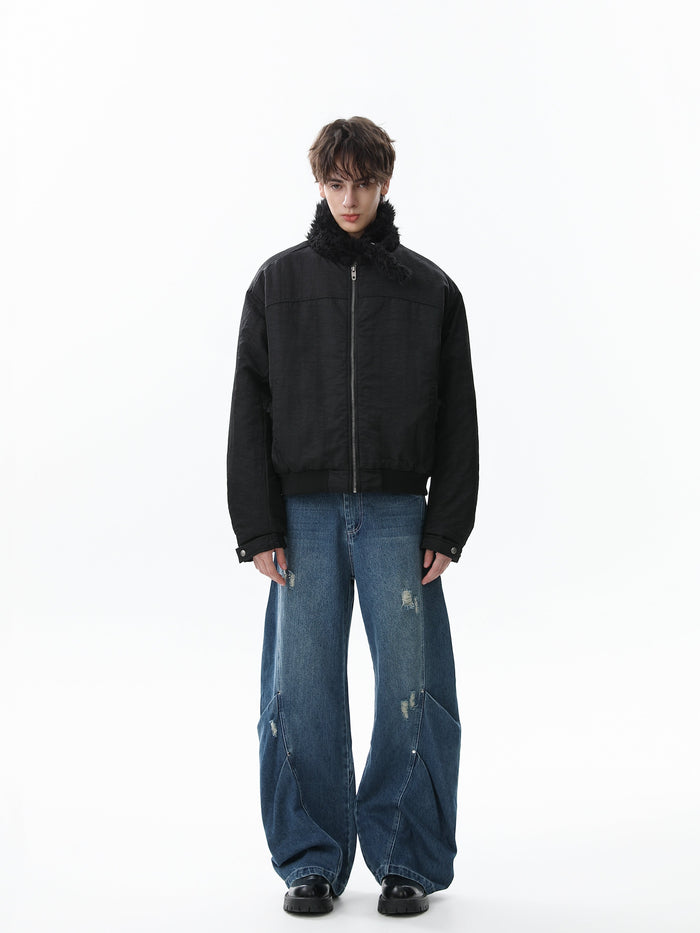 Black bomber jacket worn closed on a model with faux fur collar and long sleeves