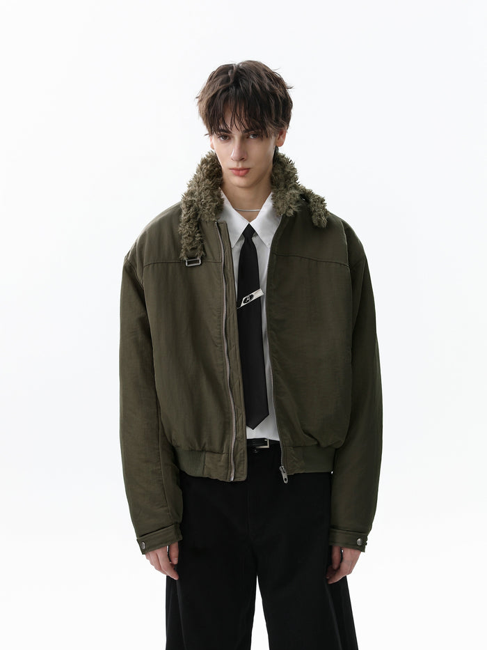 Olive green bomber jacket worn open on a model with faux fur collar and tie styling