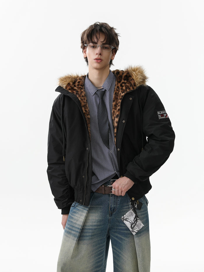Model wearing black faux-fur hooded bomber jacket with leopard-print lining and wide jeans