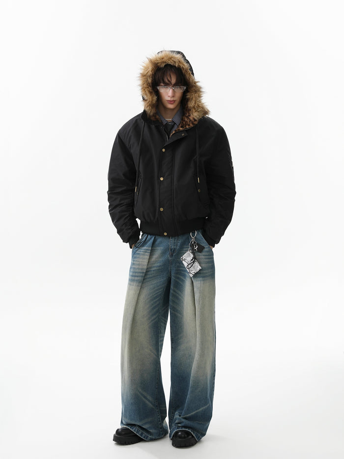 Model wearing black bomber jacket with faux-fur hood up, front view