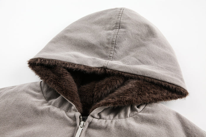 Close-up of gray hood with dark faux fur trim and zipper top