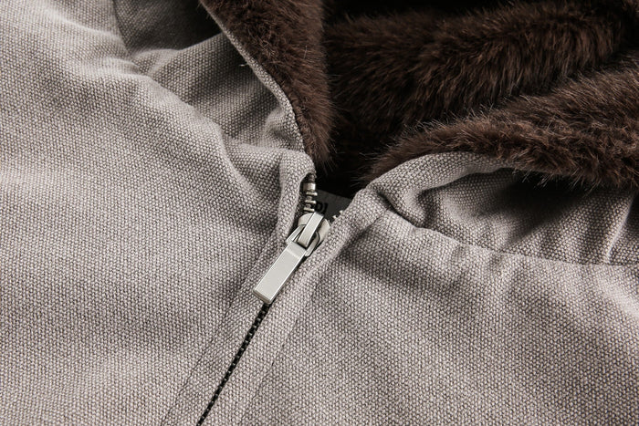 Close-up of gray canvas shell and silver zipper with faux fur lining