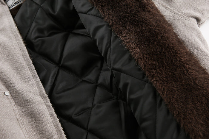 Close-up of black quilted lining and brown faux fur trim inside the jacket
