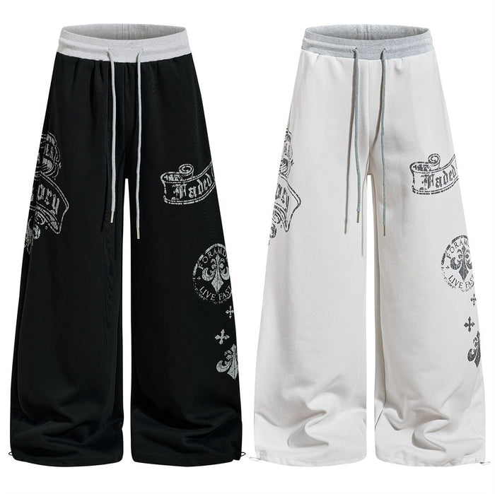 Black and white wide-leg sweatpants with gothic graphic prints, front view side by side