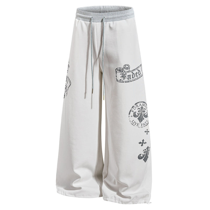 White wide-leg sweatpants with gothic graphic prints and drawstring waist, front view