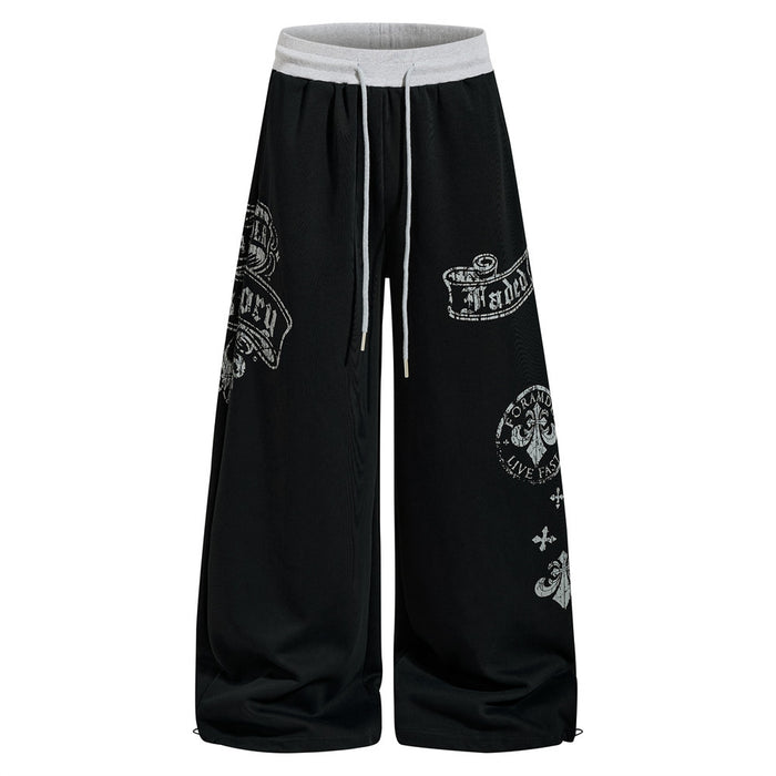 Black wide-leg sweatpants with gothic graphic prints and drawstring waist, front view