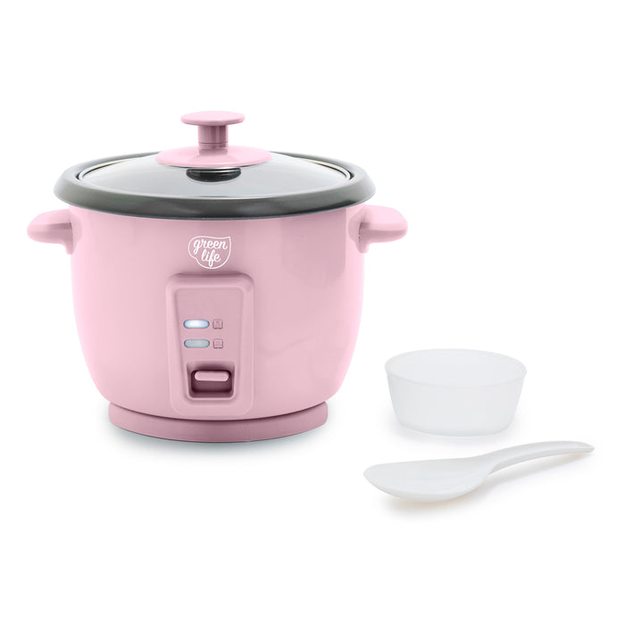 Pink rice cooker with a white bowl and spoon on a white background