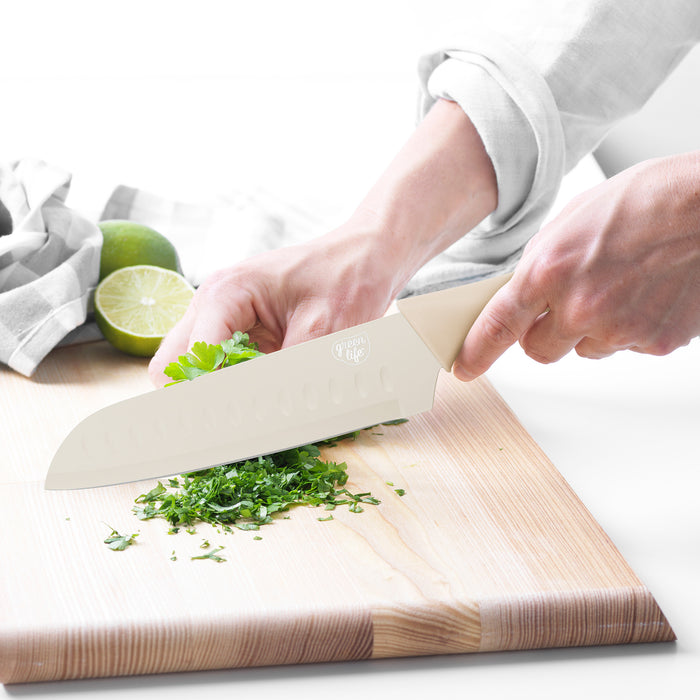 GreenLife taupe 6-piece cutlery set on wooden board with chopped herbs and a halved lime.