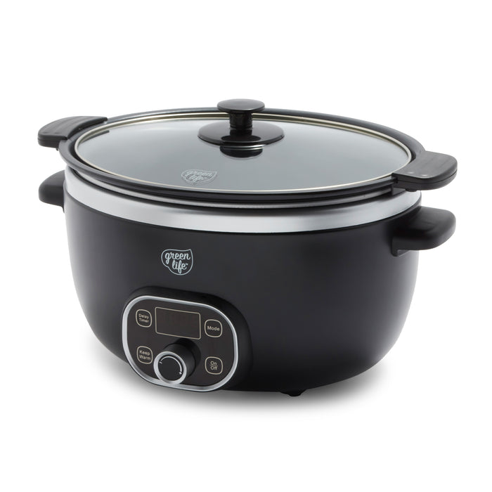 Black slow cooker with a glass lid on a white background