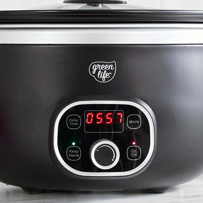 Black slow cooker with digital control panel and 'greenlife' branding.