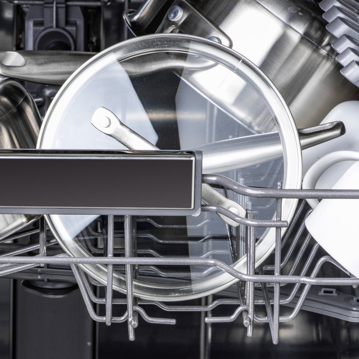 Two clear tempered glass lids with stainless steel handles, sizes 9.5 and 11, inside a dishwasher rack.