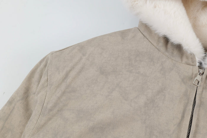 Close-up of beige jacket shoulder and zipper near the faux-fur lined hood