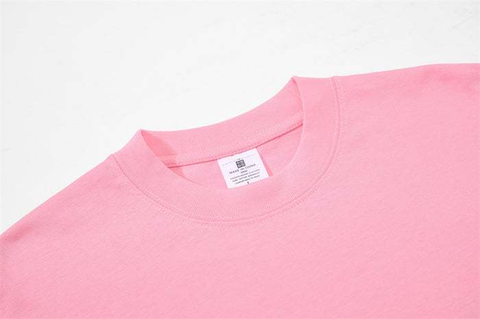 Close-up of light pink tee neckline and inner label