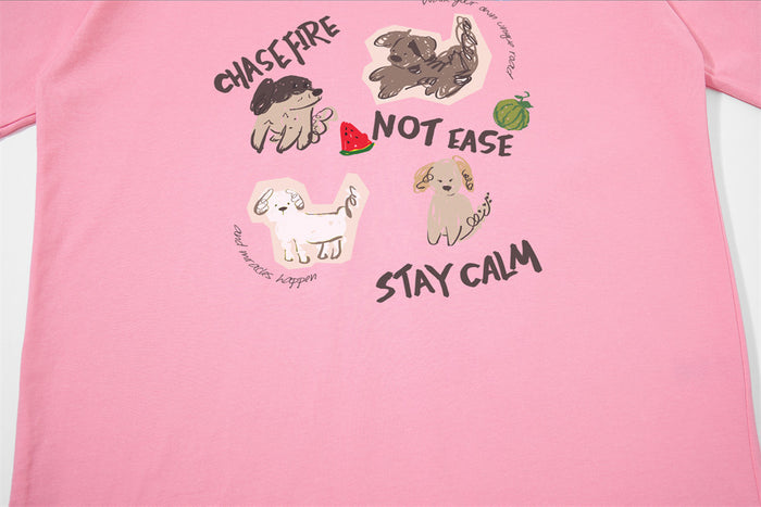 Close-up of light pink tee front graphic with cartoon dogs and bold text