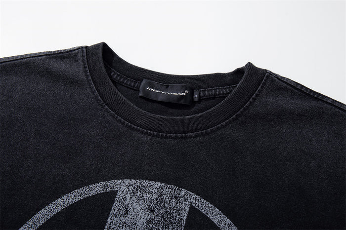 Close-up of black crew neck collar and faded aWS graphic print
