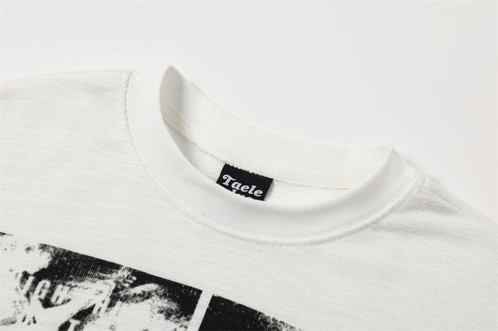 Close-up of white crew neck collar with Taele Plus label