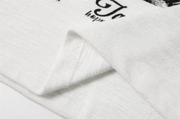 Close-up of white sleeve cuff and printed graphic detail