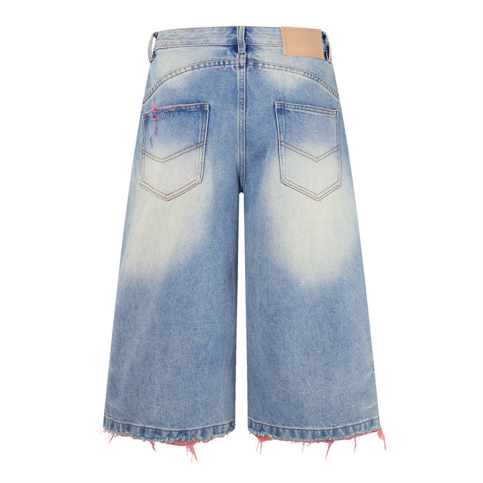Back view of washed blue wide-leg denim shorts with two patch pockets and pink thread